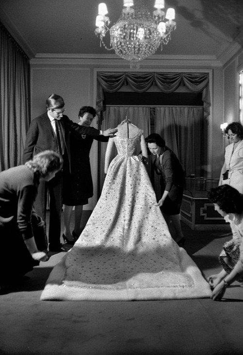 Yves Saint Laurent putting the finishing touches on Farah Diba&#8217;s wedding dress, 1959.