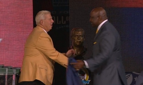 Bill Parcells shakes hands with George Martin after the two unveil Parcells' bust. (ESPN)