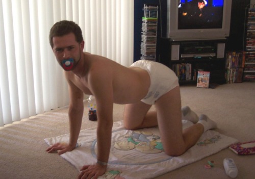 thedominantdaddy:

Corey was, as his daddy put it, “cranky”.  He didn’t like his new infantile status, or having to wear diapers, or having to crawl, and for all this he was glaring at his daddy even as he sucked his paci.  He should be careful though.  Unbeknownst to Corey, Daddy has gotten the idea that the remedy for a cranky baby is a suppository…