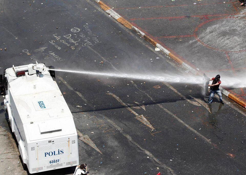 A protester against water canon earlier today in Taksim