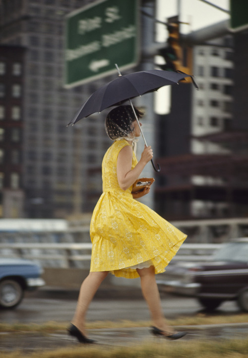 natgeofound:

A woman in a yellow dress uses an umbrella to keep dry in Saint Louis, Missouri, November 1965.Photograph by Bruce Dale, National Geographic
