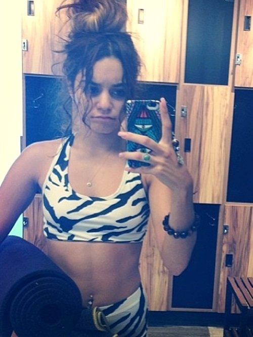 Vanessa Hudgens looks constipated while hiding from lions in a zebra striped sports bra and shorts&#8230;