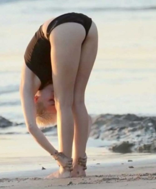 Miley Cyrus grabs her ankles for a yummy ass shot, slight pussy bulge