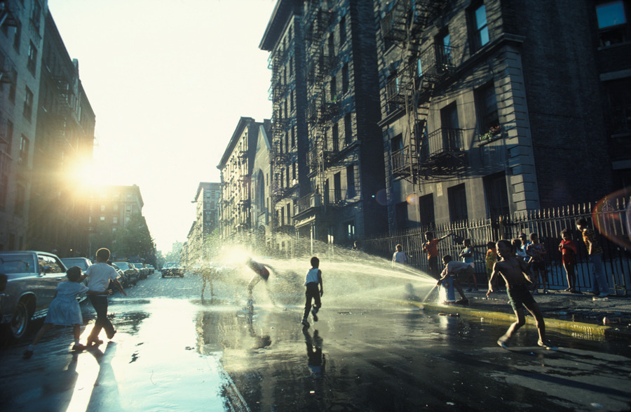 A fire hydrant refreshes youngsters on a hot day in Harlem, New York, 1977.Photograph by Leroy H. Woodson, National Geographic