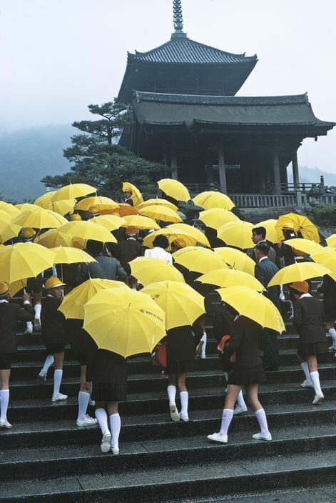 
Japan. School children with umbrellas visiting a temple. 1977.
