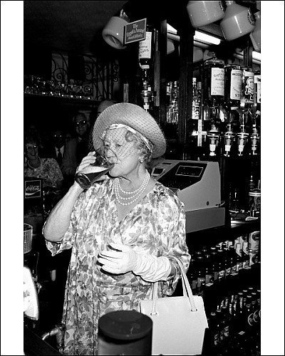 historicaltimes:

Queen mother enjoys a drink after pouring her own beer at the Queens Head pub in Stepney in London’s East End. July 16, 1987
