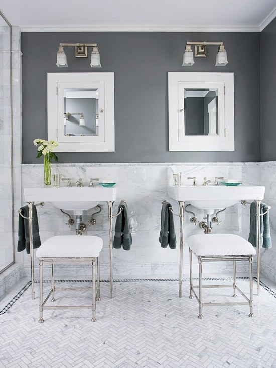 (via grey decor / Symmetrical Vanities This vanity area is a study in symmetry that helps the small space keep a calm, elegant look. Matching console vanities and coordinating stools stand beneath square recessed medicine cabinets like perfect partners. Crisp white marble resting beneath the charcoal-gray upper walls contributes to the clean, sleek decor.)