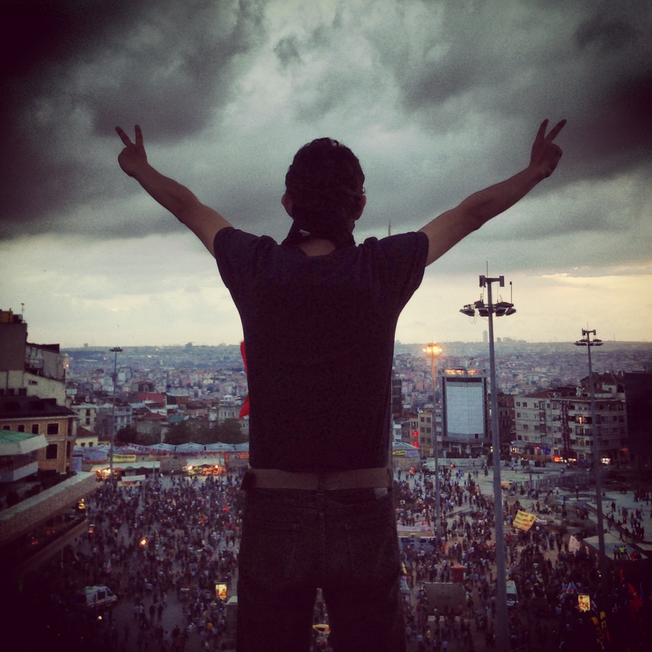 A protester on top of Ataturk Cultural Center overlooking Taksim Square yesterday.