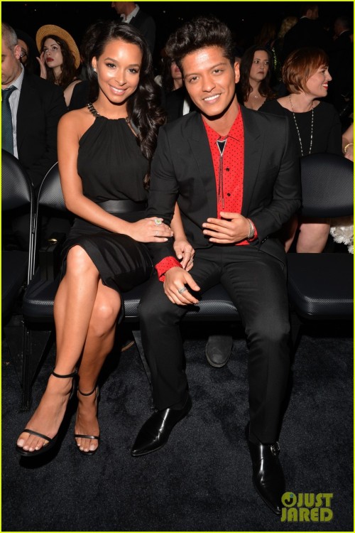 Bruno Mars sits next to his girlfriend Jessica Caban while attending the 2014 Grammy Awards