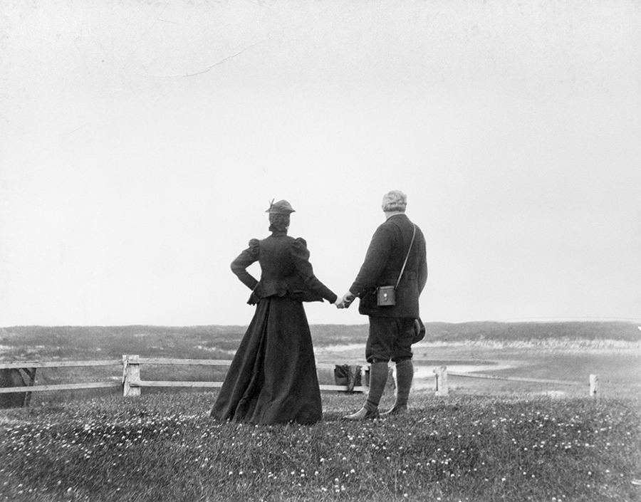 Alexander Graham Bell and his wife Mabel hold hands at the water’s edge in Nova Scotia in 1898.Bell Collection