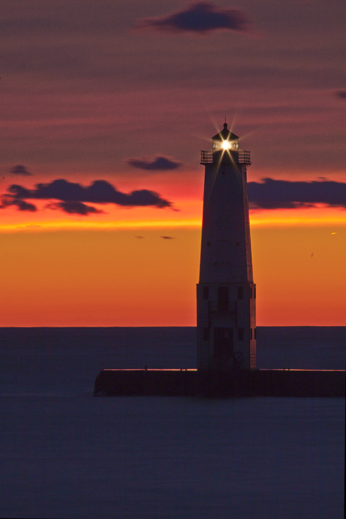 travelingcolors:

Sunset at Frankfort Lighthouse | Michigan (by pixquik)
