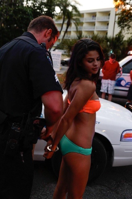 Movie still of Selena Gomez in a bikini gettin arrested in Springbreakers&#8230;