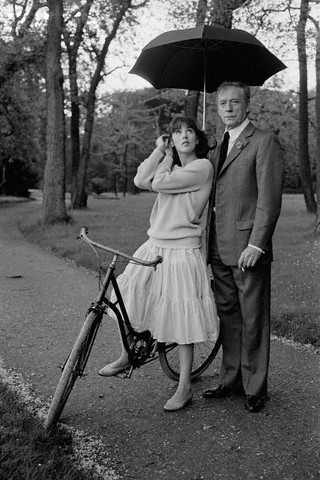 Isabelle Adjani rides a bike Yves Montand holds an umbrella