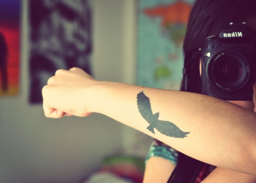 tattoo of a flying bird.