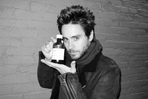 Jared holding his cough medicine.