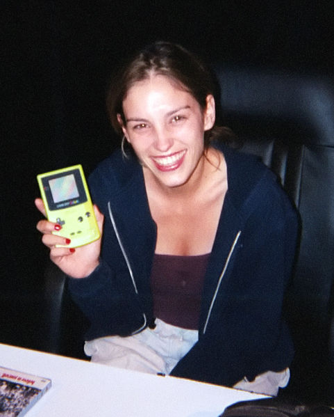 Amy Jo Johnson shows off a neon green Gameboy