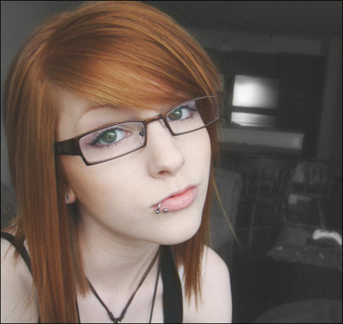 red hair and lip piercing. edit: and lip piercing :3