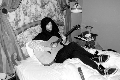 Jared playing guitar in his hotel room.