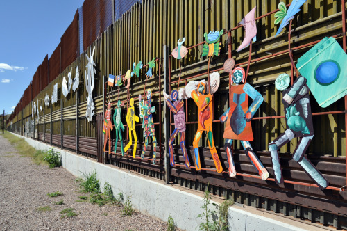 fuckyeahchicanopower:

“A painted metal mural attached to the Mexican side of the US border wall in the city of Heroica Nogales, Sonora. The mural is titled “Paseo de Humanidad” (Parade of Humanity) and was created by artists Alberto Morackis, Alfred Quiróz and Guadalupe Serrano. It depict the struggles and harsh realities of economic refugees traveling through the Sonoran desert to reach the US.”