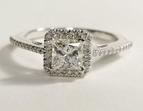 Princess cut halo diamond engagement ring in 18K white gold.