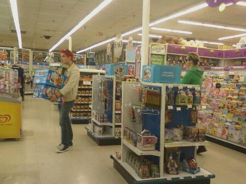 Gerard & Mikey Shopping at Toys R Us . <3 o.o My Best Friend just saw them there, she knows how obsessed i am with mcr , so she told me they were there and i didn’t believe her. She sent me this picture for proof. I know some of you think it’s an invasion of privacy or whatever but they are out in public, so it’s not even that bad. The only thing that makes it seem creepy is that its from a distance, but she was too nervous to ask for a picture with them. Gerard and Mikey did see her though, and Gee Smiled. While Mikey kept his pokerface on. lol she was wearing a mcr shirt too and she’s going to their show tonight. oh.my.god. i was freaking out so bad when she sent me this. I wanted to jump out a window. For the people who think this is adorable, your welcome ^_^ and to the people who think it’s messed up that i uploaded this, i thought so too at first but then figured, how would i feel if someone had this adorable picture of my favorite band and kept it to them self. here’s my friend’s link : http://voodoolikeyoudo.tumblr.com/  