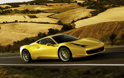 Yellow Ferrari 458 Italia on the Italian country roads