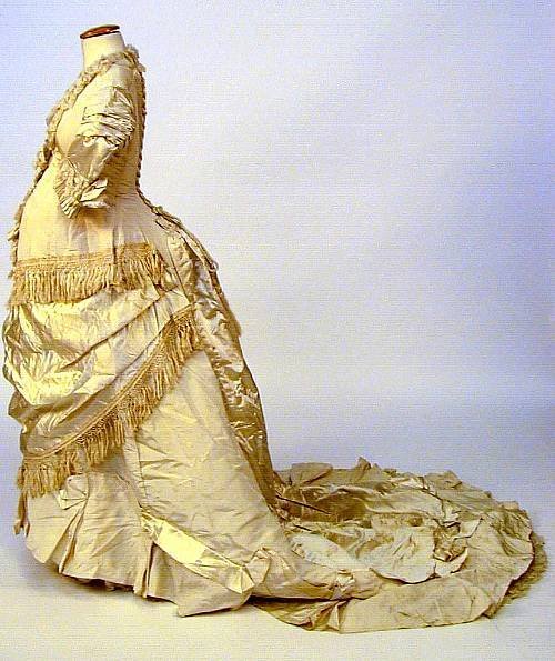 A onepiece maternity trained wedding gown circa 1880 of cream finely 