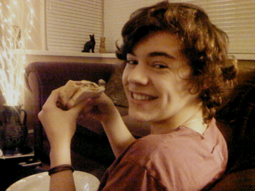Harry eating what I presume to be an Egg McMuffin.