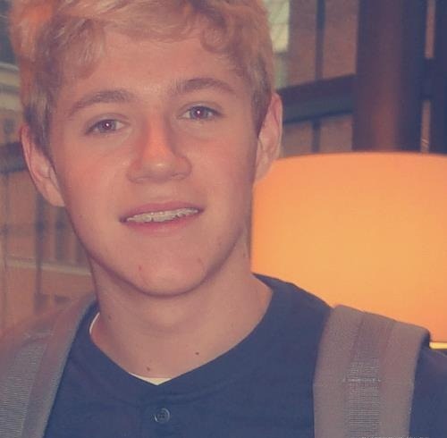 Niall with his braces :( he doesnt look as cheery