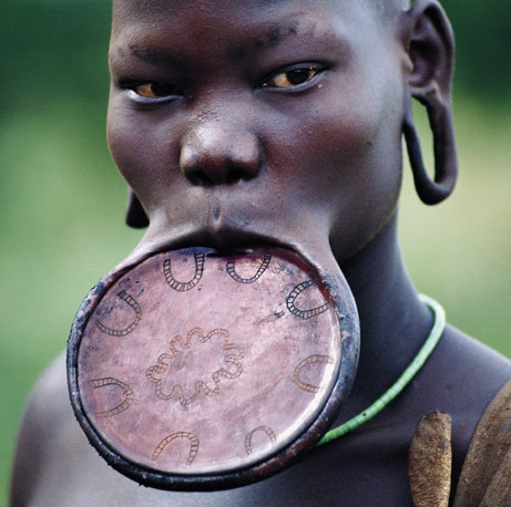 Surma woman Ethiopia Piercing and lip plates are a strong part of the Suri