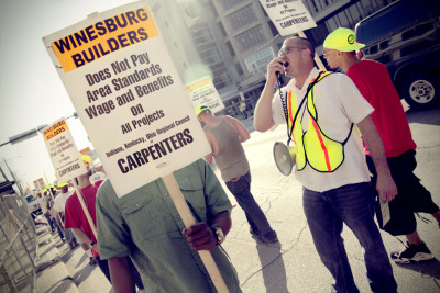 RATS &#8212; Carpenters near the downtown construction site at Cleveland State University&#8217;s Campus Village protest the employment practices of Winesburg Builders on March 22, 2012. More than 30 pickets upset with Winesburg&#8217;s wage and benefit standards marched up and down a small stretch of Chester Avenue hollering, &#8220;Who are the rats? Winesburg Builders are the rats!&#8221; Photo by Brandon Blackwell @CapturedCLE