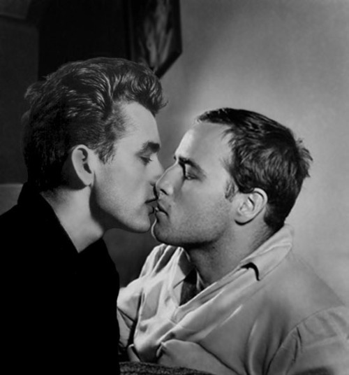  James Dean (1931-55) Kisses Marlon Brando (1924-2004)—Two Men (then young studs) with a Decidedly Gay Side* Living, as they did, in very homophobic times, the two actors hid their relationships with men outside of the Hollywood community that knew about their private lives.  As the discussion below indicates, Dean and Brando were not alone among prominent gay (or bi) actors then known outside of Hollywood as entirely straight male icons. We report below what we have learned about these actors, proud, like they were, proud of who we are—gay, straight or bi! Dean avoided military service on grounds of his sexuality (when asked, he told), but “when questioned” by others, he provided a more nuanced reply, suggesting he was bisexual: ”No, I am not a homosexual. But, I’m also not going to go through life with one hand tied behind my back.” (Source: http://en.wikipedia.org/wiki/James_Dean) In the next post, we’ll see the on-screen three-way relationship with gay actor, Sal Mineo, whom Dean kisses.  Stay tuned. Before Brando, one of Dean’s closest boy friends was his UCLA roommate and screenwriter, William Bast, who later admitted that “their friendship had included some sexual intimacy.” [Source: William Bast, Surviving James Dean (Barricade Books, 2006), pp. 133, 183-232 as cited by http://en.wikipedia.org/wiki/James_Dean] Dean was among a number of Brando’s boy friends. In his Brando Unzipped, biographer Darwin Porter tells us: “James Dean was one of Brando’s most lasting yet troubled gay relationships. They had a relationship for a number of years but it was always turbulent…. At one point they had a big stand-up fight at a party in Santa Monica, California, witnessed by dozens of people…. His affair with Montgomery Clift was a long and enduring relationship…. Marlon had a bit of a fling with Cary Grant, spending a weekend with him in San Francisco. Cary was also pursuing the actor Stewart Granger, who became another of Marlon’s conquests…. Marlon admired John Gielgud but they didn’t have a relationship, rather, Brando performed sexual favours for Gielgud and told friends, ‘I owed it to him because he really helped me with lines in Julius Caesar.’” [Source: http://www.contactmusic.com/news-article/brando-book-details-string-of-gay-celebrity-affairs_26_01_2006] Interviewed by Gary Carey for his  The Only Contender (his 1976 biography), Brando stated: “Homosexuality is so much in fashion it no longer makes news. Like a large number of men, I, too, have had homosexual experiences and I am not ashamed. I have never paid much attention to what people think about me.” [Source: Keith Stern, Queers in History, (Ben Bella Books, 2009), p. 70 as cited in http://en.wikipedia.org/wiki/Marlon_Brando#cite_note-queers_in_history-40] 