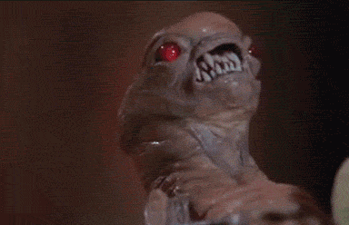 Moving gif of a newborn Alien, ie, a chestburster, wearing a boater.