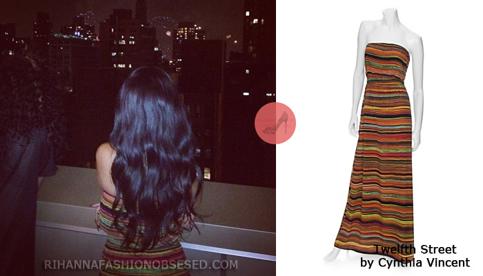Rihanna posted a picture on her instagram watching fireworks on the 4th of July next to her BFF Melissa. wearing a colorful $325.00 strapless maxi maxi dress from Intermix by Twelfth Street by Cynthia Vincent.
The dress is described  a simple and effortless strapless dress that has an elasticized top and waist, and then the ever so slightly flared skirt falls straight down to the ground with a 15&#8221; slit on the side. Styled in a lightweight silk crepe de chine, and it is unlined in a multi stripe of rust, burgundy, eggplant, grass green, and mustard.