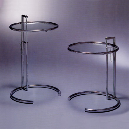 The austerely chic E-1027 chrome and glass table (1929) was designed by Grey for the E-1027 house at Roquebrune-Cap-Martin she built and shared with her lover, Jean Badovici. The name is a numeric code for their initials - E for Eileen, 10 for J (10th letter of the alphabet), 2 for B and 7 for G.