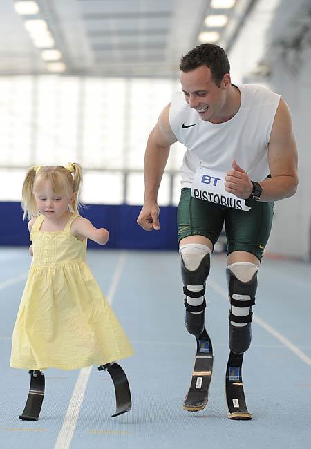 If all of the Olympics were reduced to just this one photo of Oscar Pistorius running with 5-year-old Ellie May Challis, by photographed by Andy Hooper, it would still be a feat of mankind.