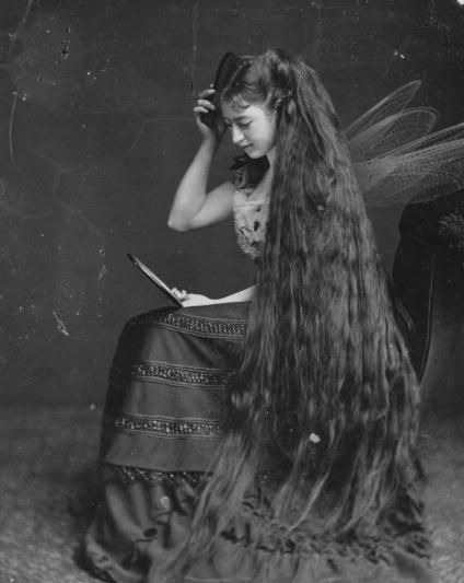 Young Victorian woman with ankle grazing hair wearing ethereal fairy ...
