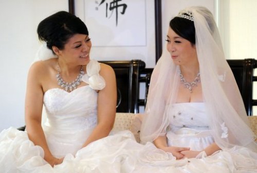 
Taiwan couple in same-sex Buddhist wedding
Two women tied the knot on Saturday in Taiwan’s first same-sex Buddhist wedding, a move rights groups hope will help make the island become the first place in Asia to legalise gay marriage.
Fish Huang and her partner You Ya-ting, both wearing traditional white bridal gowns, said “I do” in front of a Buddha statue and exchanged prayer beads rather than rings in a monastery in Taoyuan, in northern Taiwan.
Nearly 300 Buddhists chanted sutras to seek blessings for the couple, both aged 30.
Shih Chao-hui, a female Buddhist master who presided over the ritual, hailed it as a historic moment.
“We are witnessing history. The two women are willing to stand out and fight for their fate… to overcome social discrimination,” said Shih, a well-known advocate for social justice.
