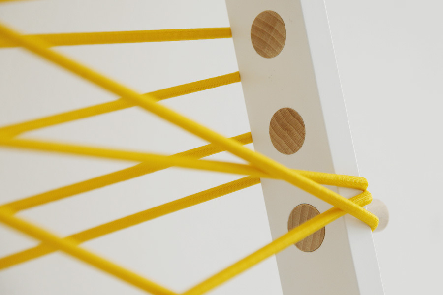 Ladder is a minimalist design created by Polish-based designer Agnieszka Mazur. Ladder is a piece of furniture designed for the hallway space. It can be used to can hang clothes, handbags, scarfs, hats, sunglasses etc. It features wooden pegs to hang jackets and a space in which a flexible cord is suspended, into which looser pieces of clothing can be placed.