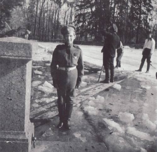 Tsarevich Alexei standing at attention in the park: 1917.