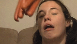 girl hit in the face with hot dogs gif