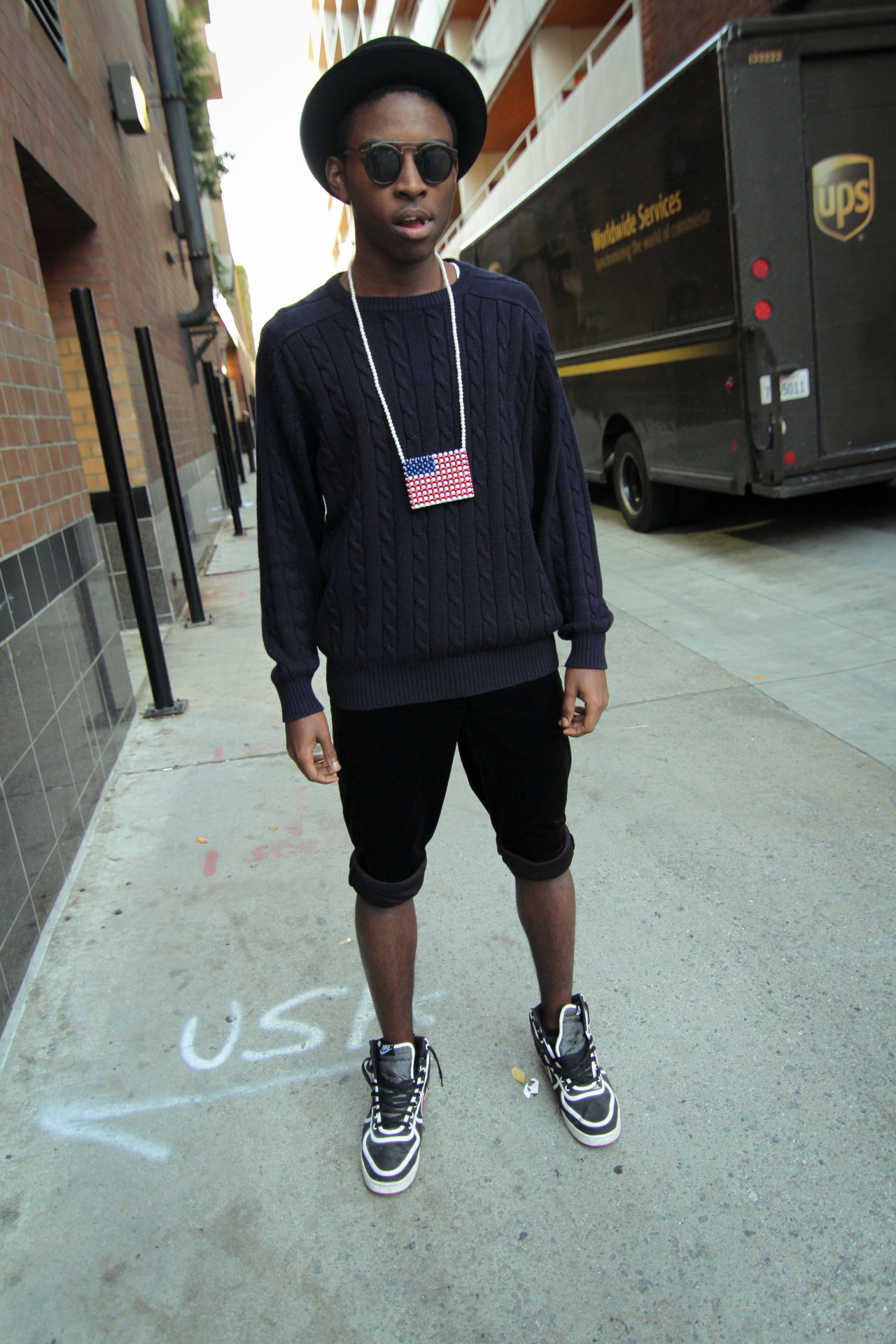 Jibril - Black America - My last look for 2012 looked quite modern. I&#8217;ve had these sneakers  forever, but never wear them much. the shorts were velvet pants rolled up, and the knitt sweater was given to me by an uncle back in paris. And the american flag chain is from Jet rag a vintage store here in LA. I loved the combo i think it really made me look like some sort of celebrity on the go&#8230;Well i was in al black, maybe Kanye on the go?