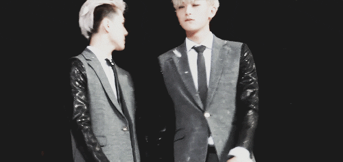 sehun attempting to throw a ball of feathers at tao’s face but fails.