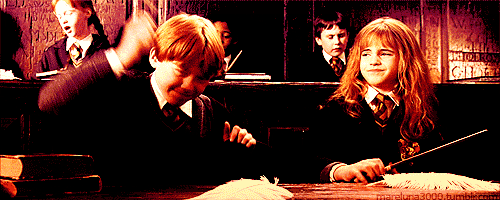 Ron waving his wand at his feather enthusiastically